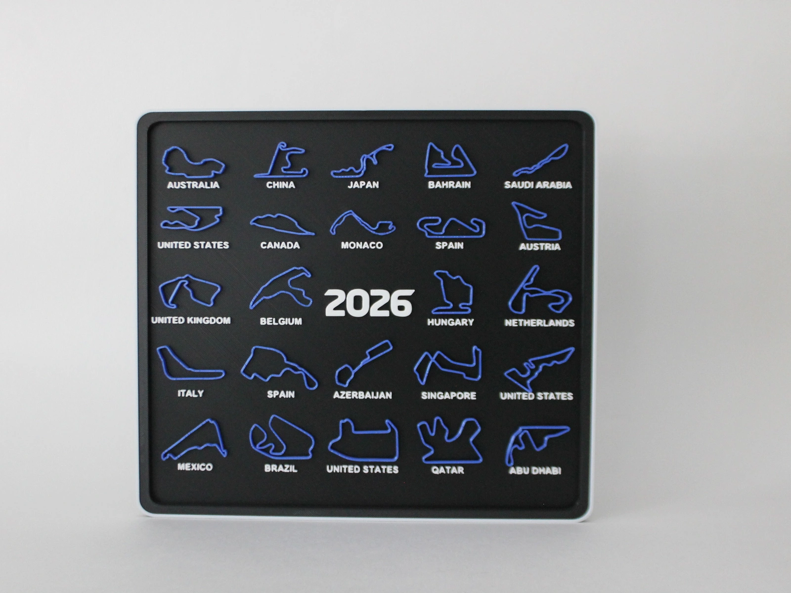 Синий календарь с трассами Формулы‑1 сезона 2026